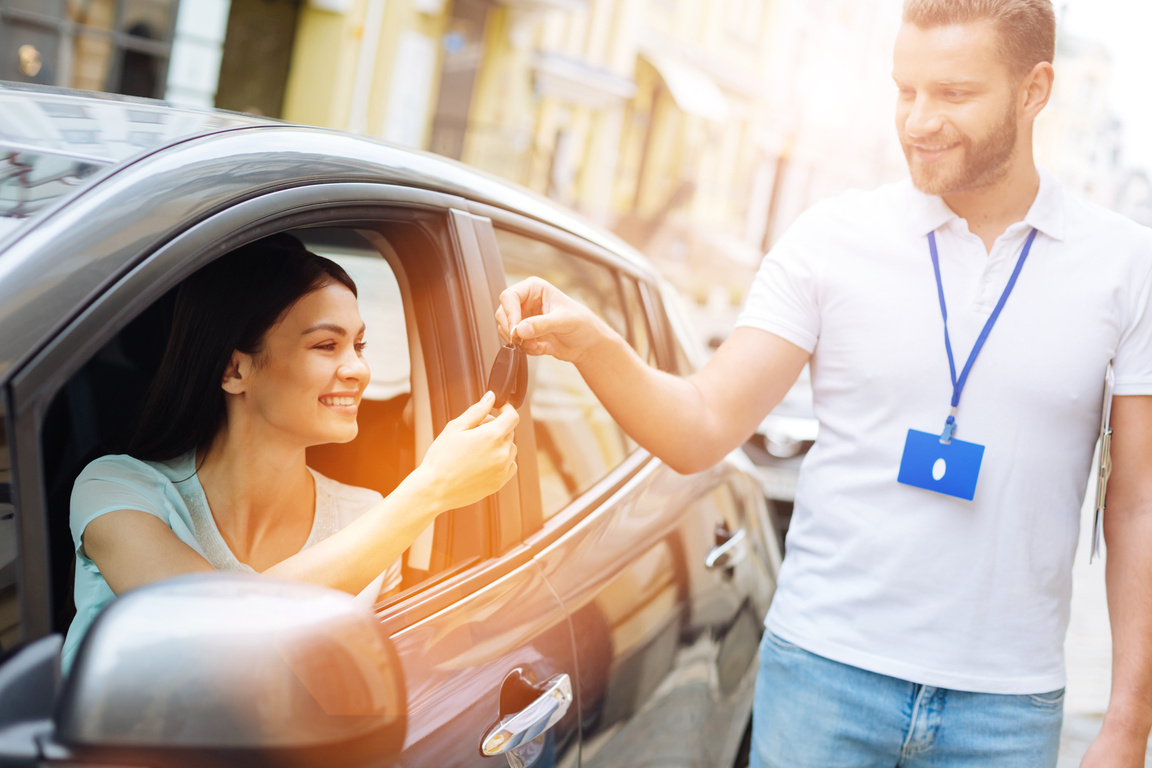 Car Rental Employee Giving Car Keys to Woman